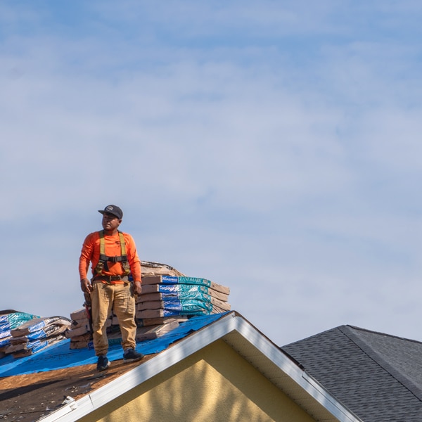 Roofing contractor standing on a roof during a roof installation
