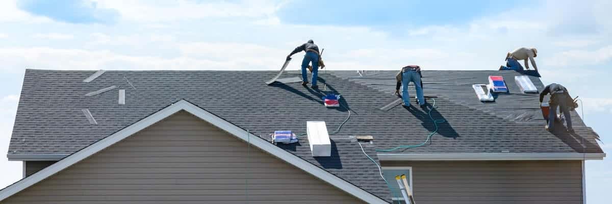 Contractors shingling tile roof on a Florida home